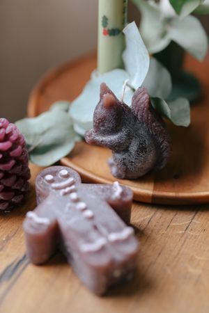 Dark brown, gingerbread man-shaped candle