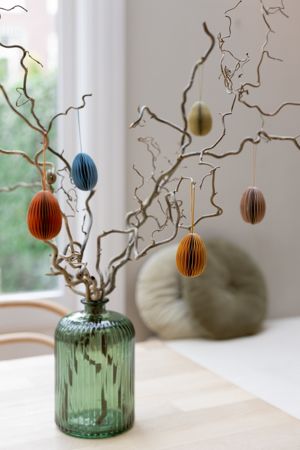 Egg-shaped, orange paper Easter ornament