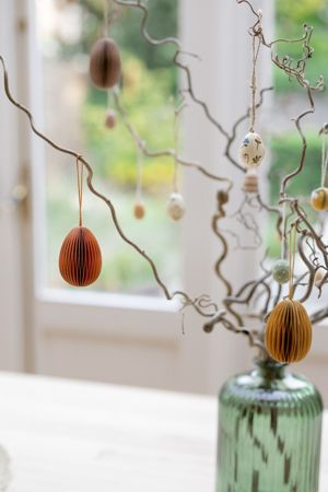 Egg-shaped, orange paper Easter ornament