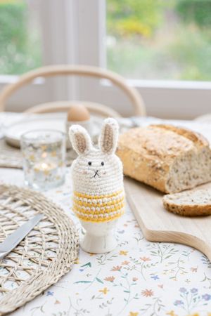 Yellow, rabbit-shaped egg cosy