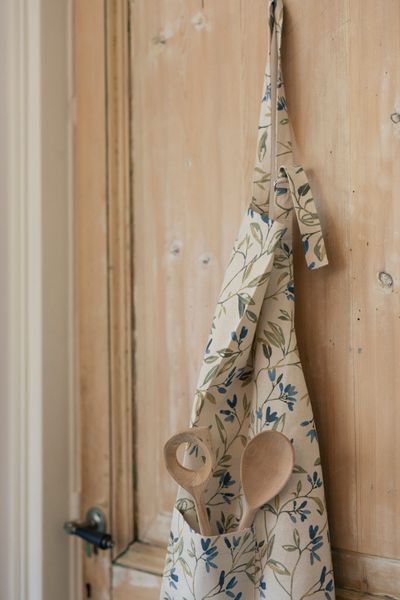 GOTS organic cotton apron with a blue, winter blossom motif